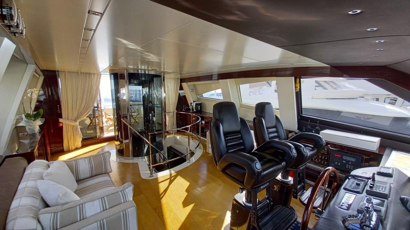 a room with a couch and a television aboard FREEDOM Yacht for Sale