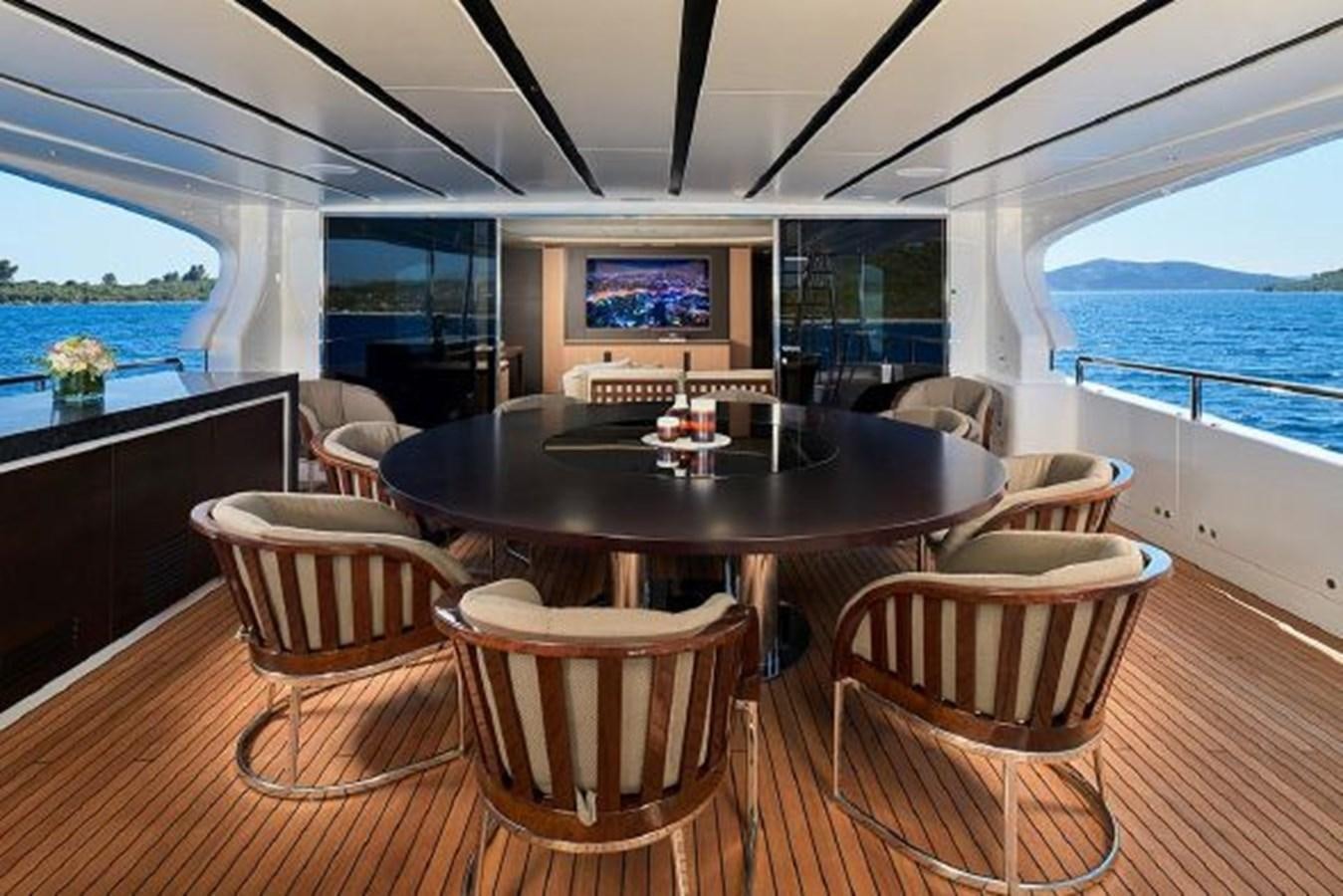 a table and chairs on a boat aboard 2018 BENETTI MEDITERRANEO 116 - VIRGIN ISLANDS Yacht for Sale