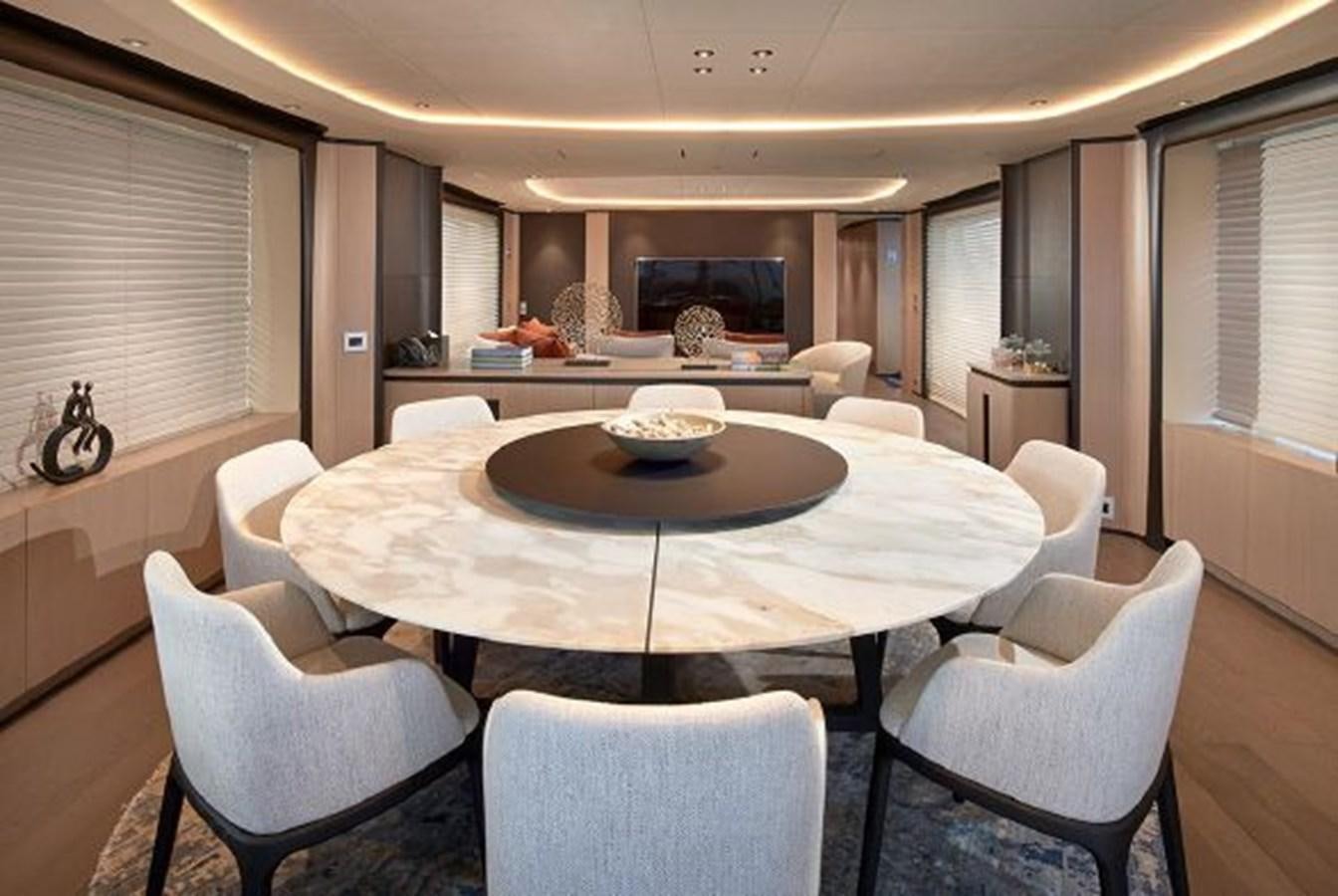 a large dining table in a living room aboard 2018 BENETTI MEDITERRANEO 116 - VIRGIN ISLANDS Yacht for Sale