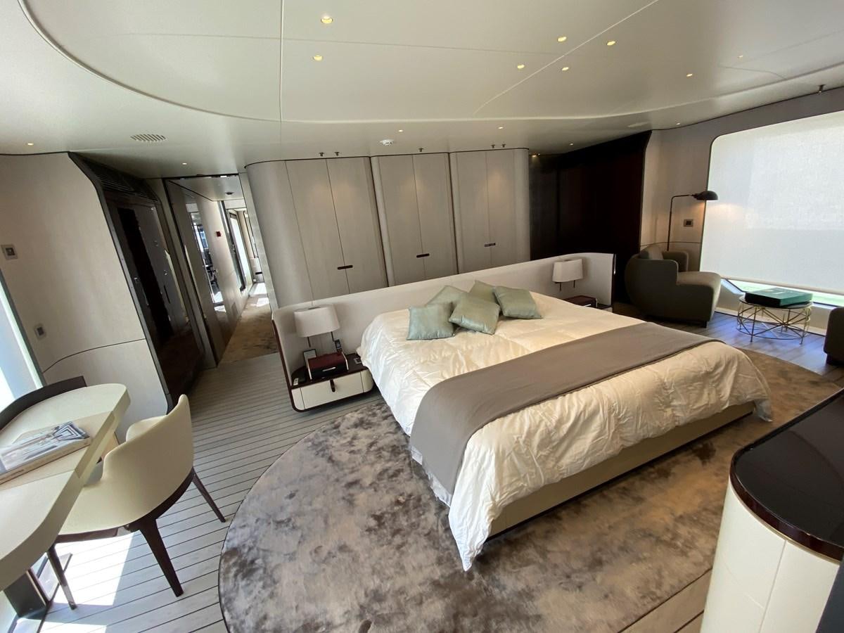 a bedroom with a bed and a chair aboard PARTNER Yacht for Sale