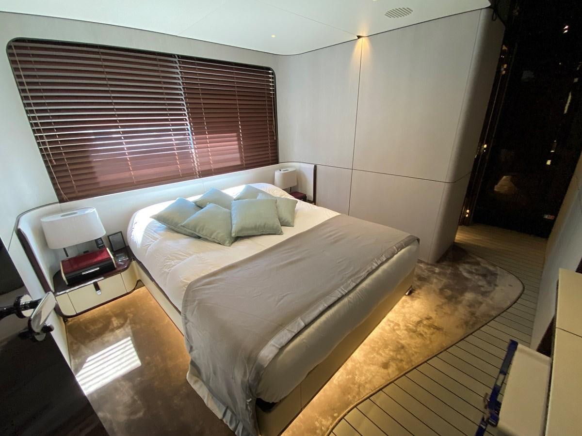 a bedroom with a bed and a desk aboard PARTNER Yacht for Sale