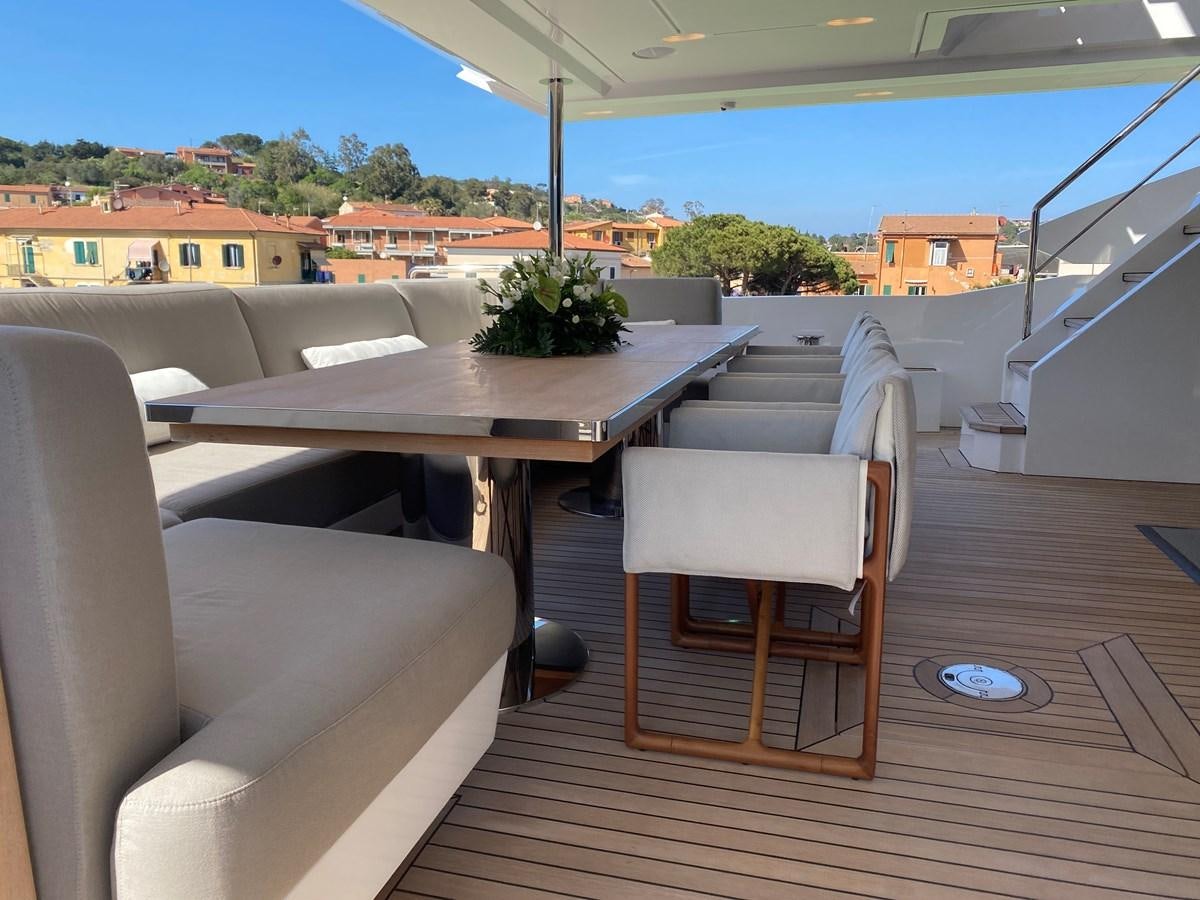 a deck with chairs and a table aboard PARTNER Yacht for Sale