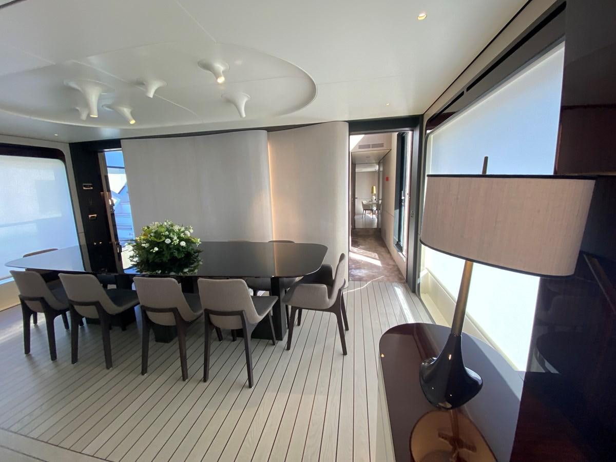 a room with tables and chairs aboard PARTNER Yacht for Sale