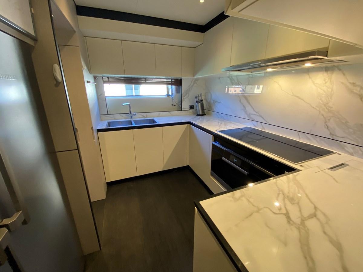 a kitchen with white cabinets aboard PARTNER Yacht for Sale