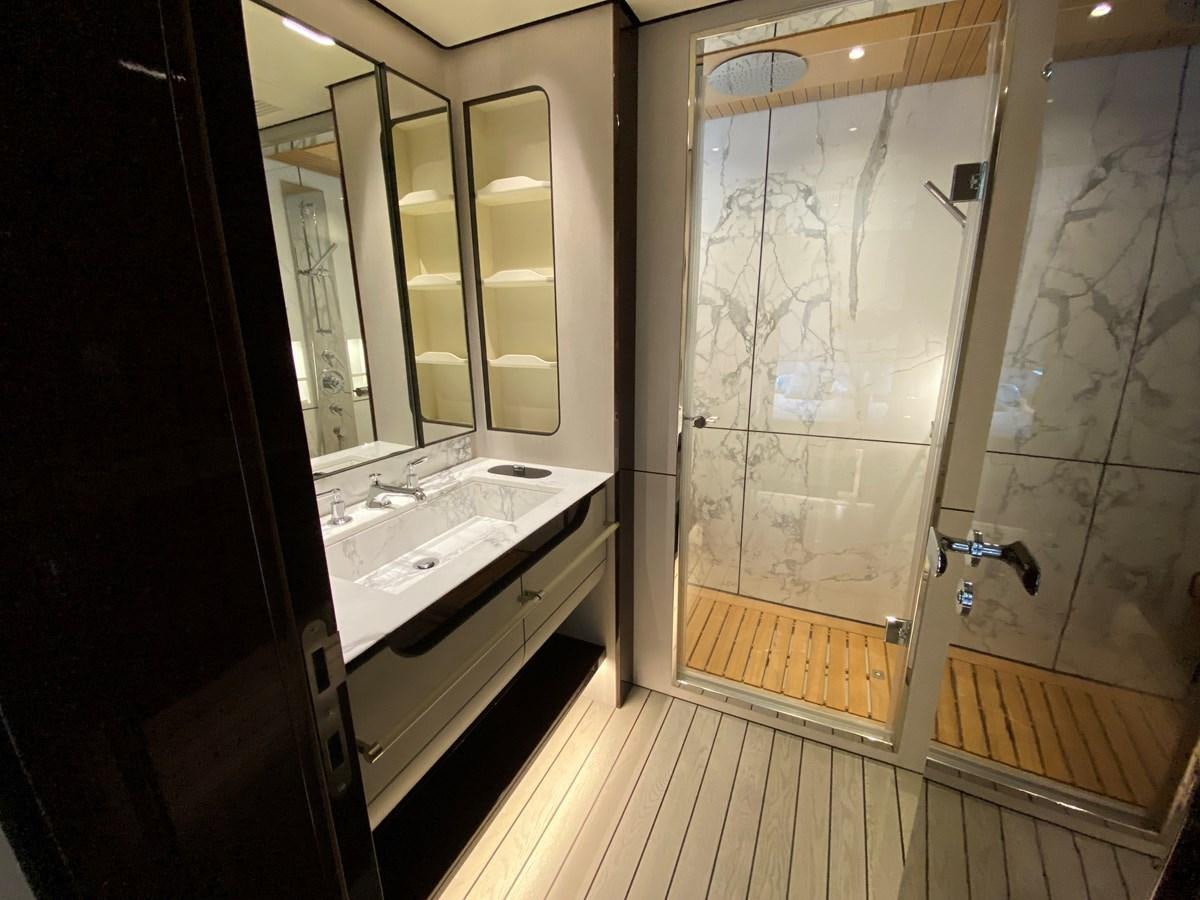 a bathroom with a glass shower door aboard PARTNER Yacht for Sale