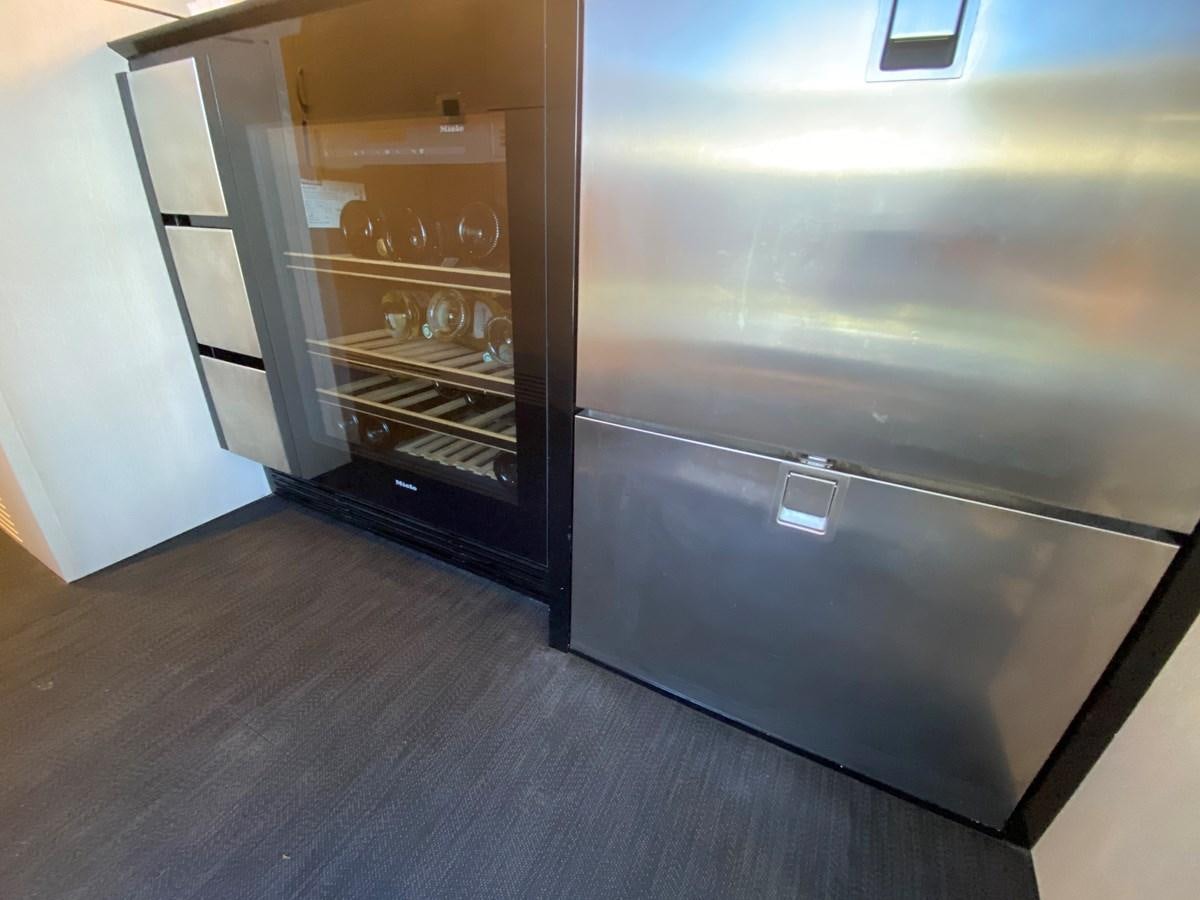 a kitchen with a large refrigerator aboard PARTNER Yacht for Sale