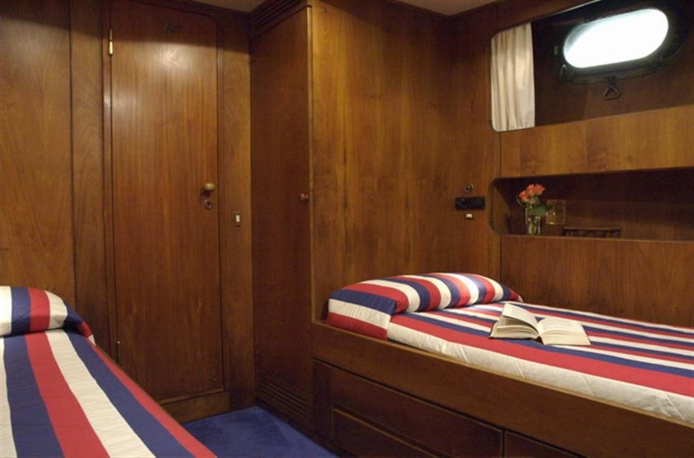 a room with a bed and a desk aboard BARCABLU Yacht for Sale