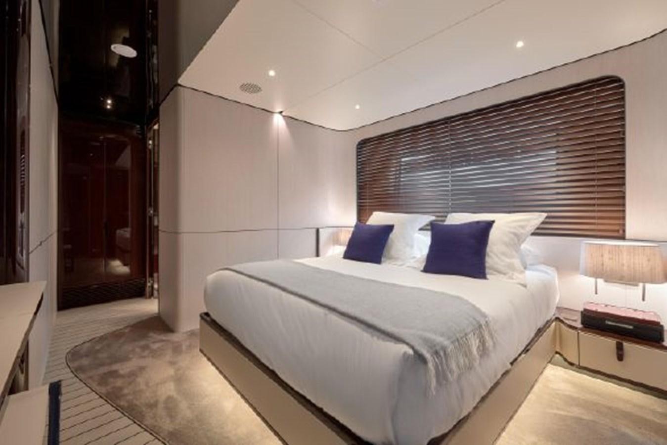 a room with a bed and a desk aboard 2019 AZIMUT GRANDE 35 METRI Yacht for Sale