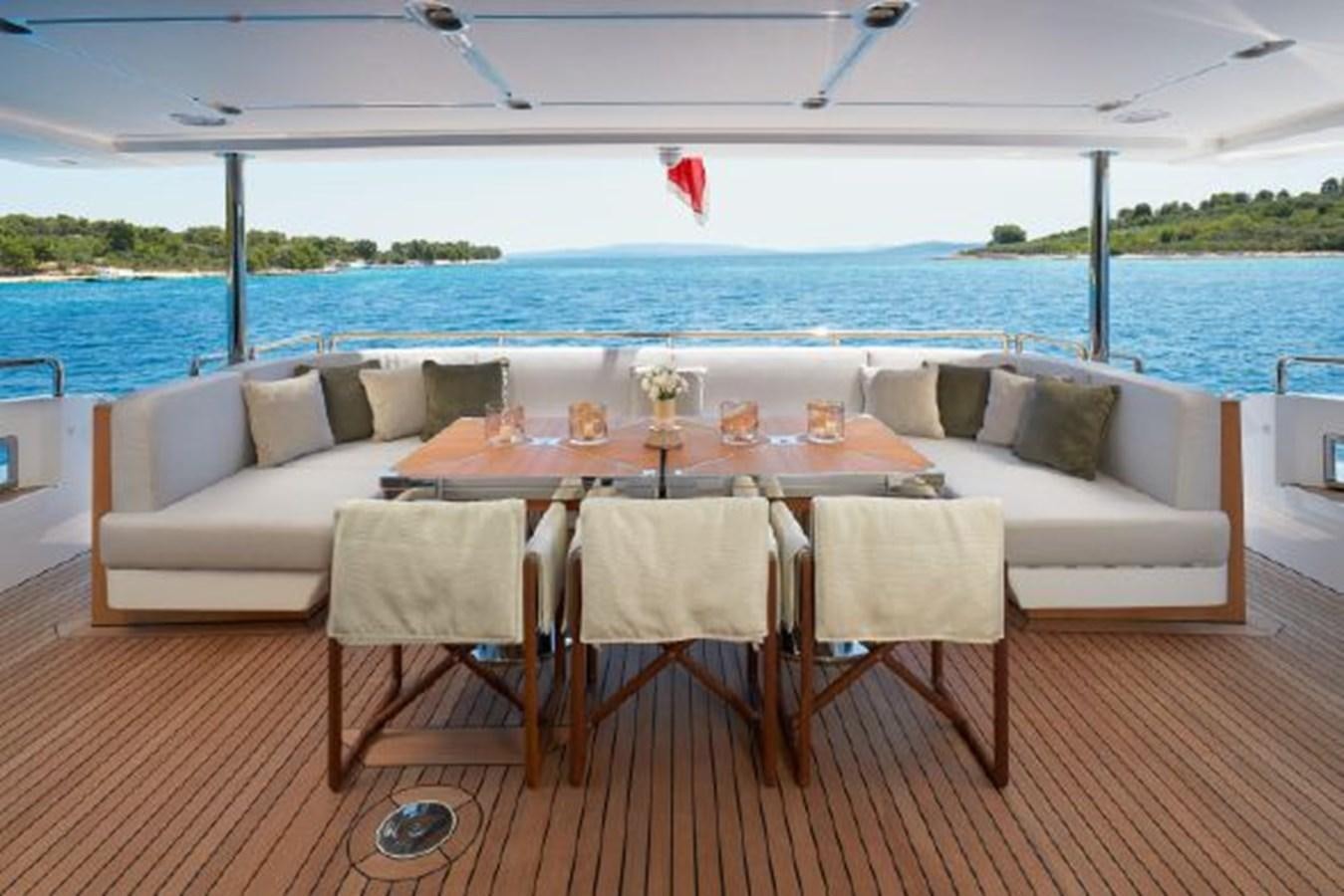 a table set for a meal on a deck overlooking the ocean aboard 2019 AZIMUT GRANDE 35 METRI Yacht for Sale
