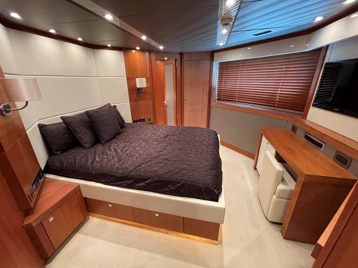 a bed in a room aboard SUNSEEKER 115/03 Yacht for Sale