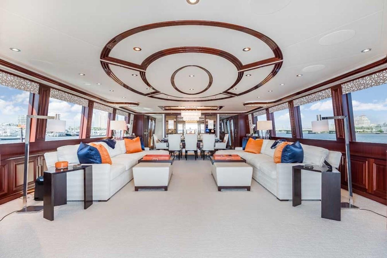 a large room with a couch and a large mirror aboard OUR HERITAGE Yacht for Sale
