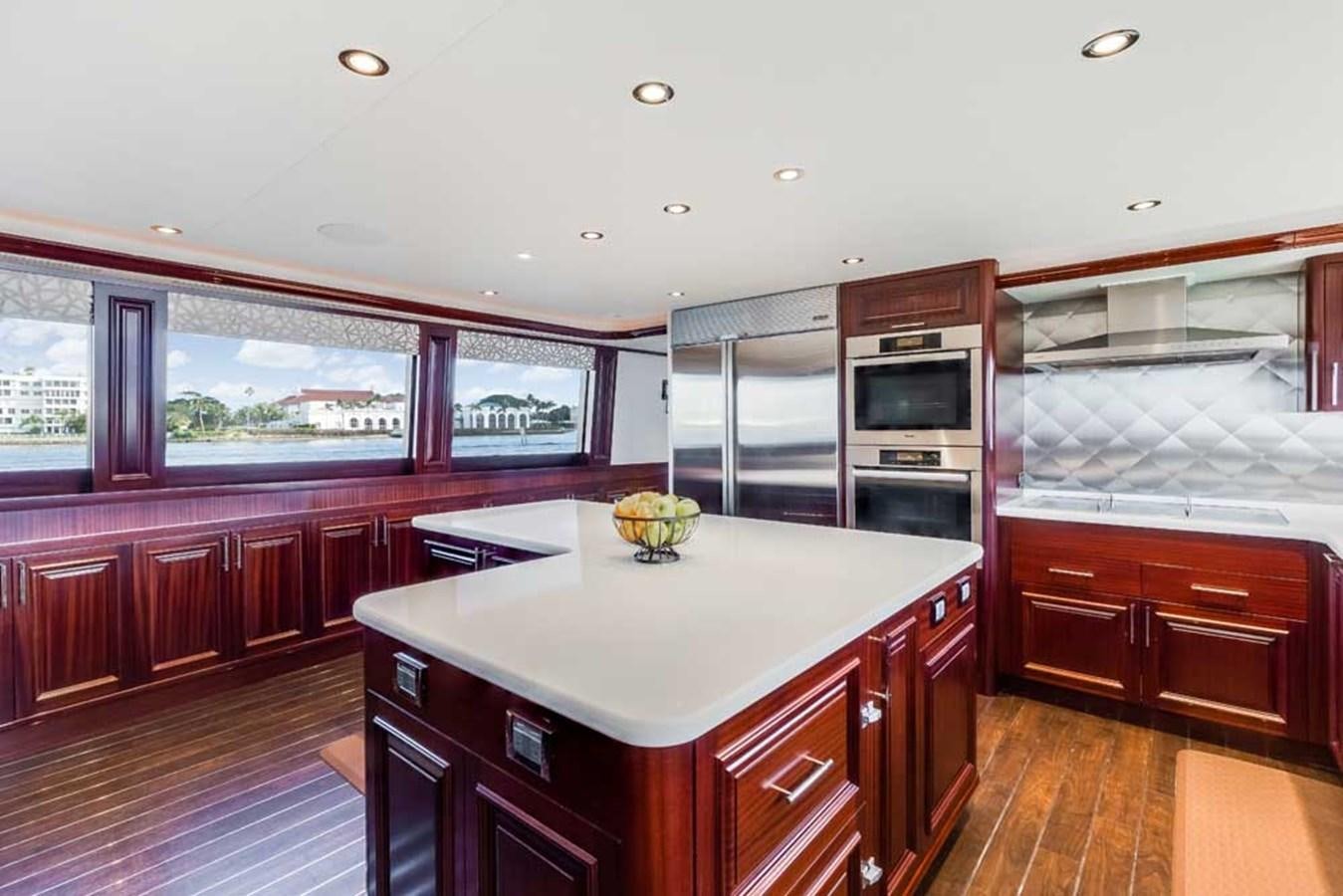 a kitchen with wooden cabinets aboard OUR HERITAGE Yacht for Sale