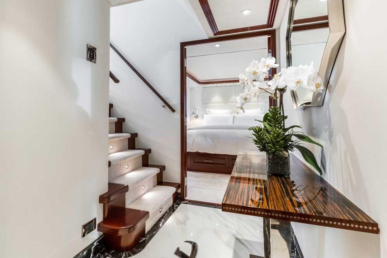 a bathroom with a mirror and a table with a plant on it aboard OUR HERITAGE Yacht for Sale