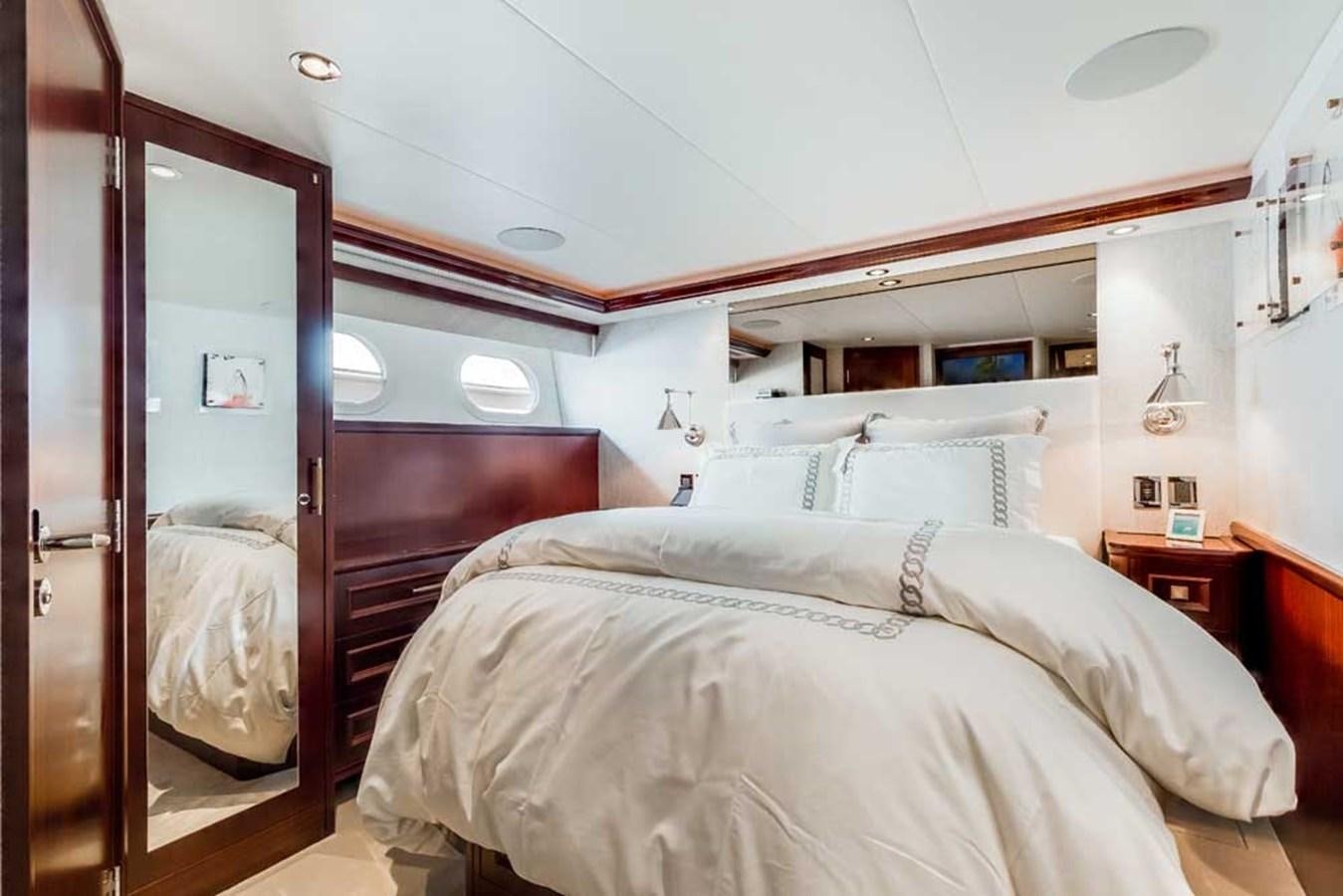 a bed with a mirror above it aboard OUR HERITAGE Yacht for Sale