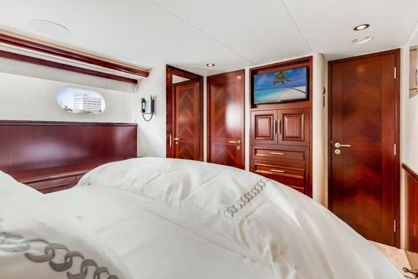 a bed with a white comforter aboard OUR HERITAGE Yacht for Sale