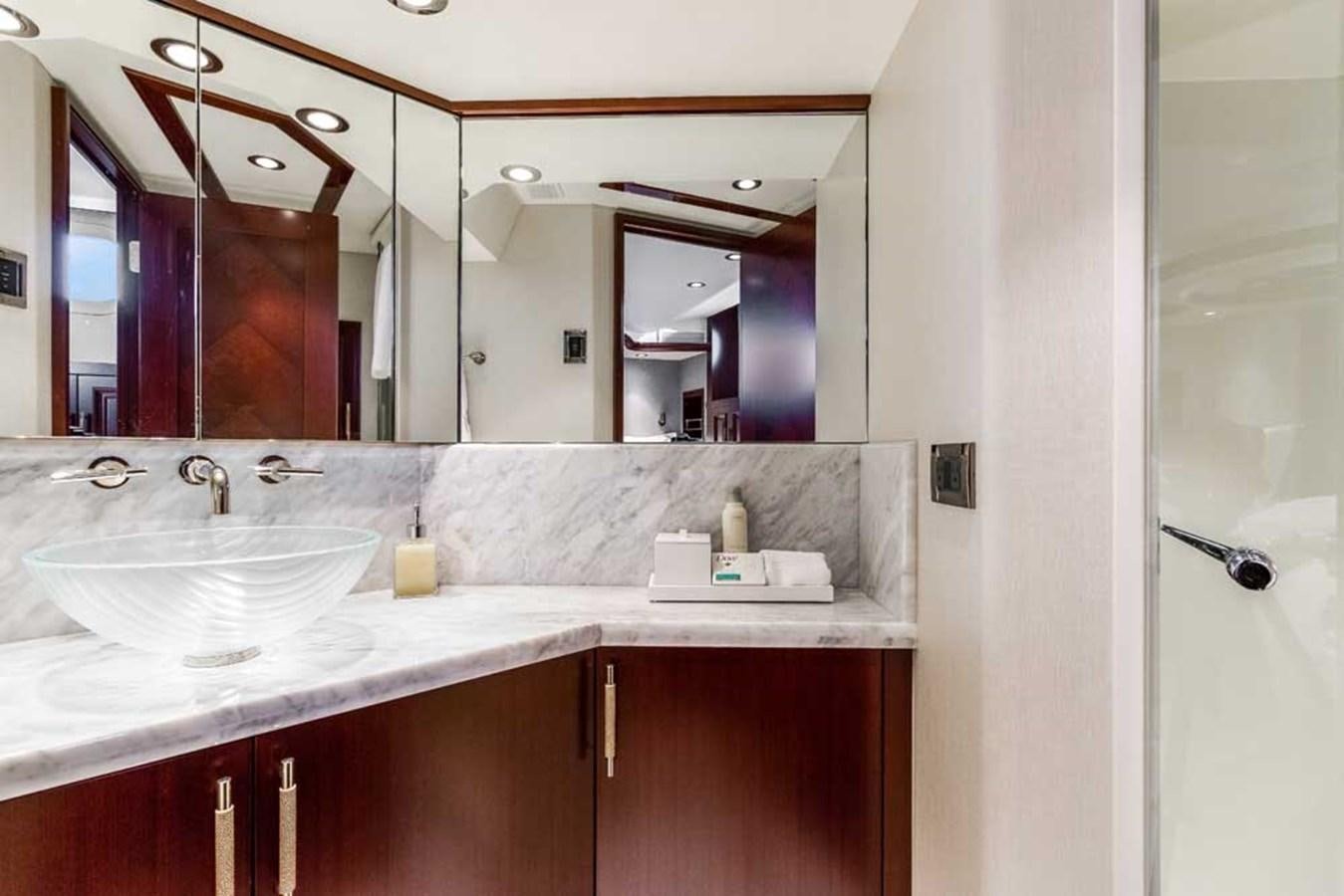 a bathroom with a large mirror aboard OUR HERITAGE Yacht for Sale