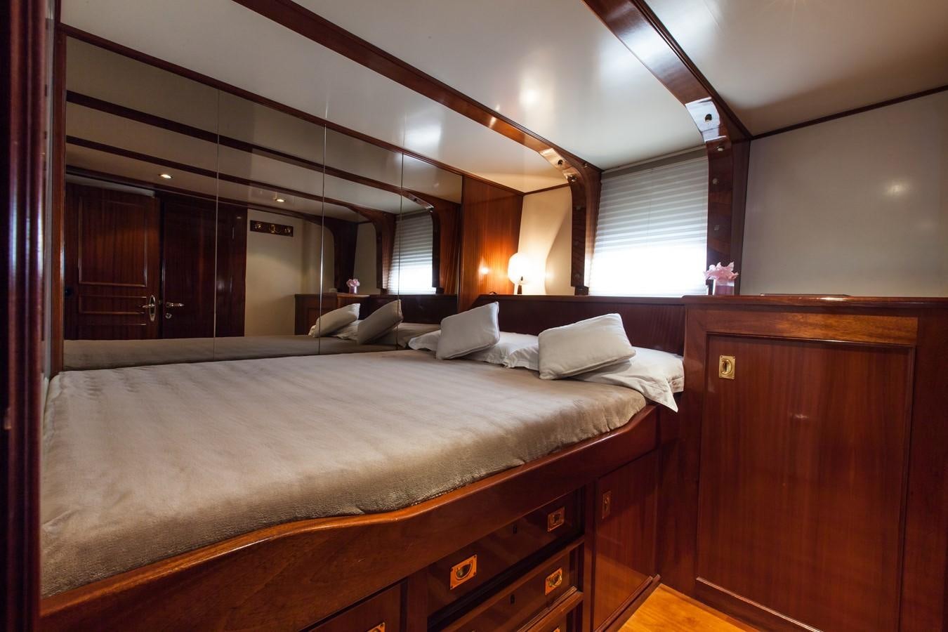 a bed with a person on the bed aboard ANTARES OF BRITAIN Yacht for Sale