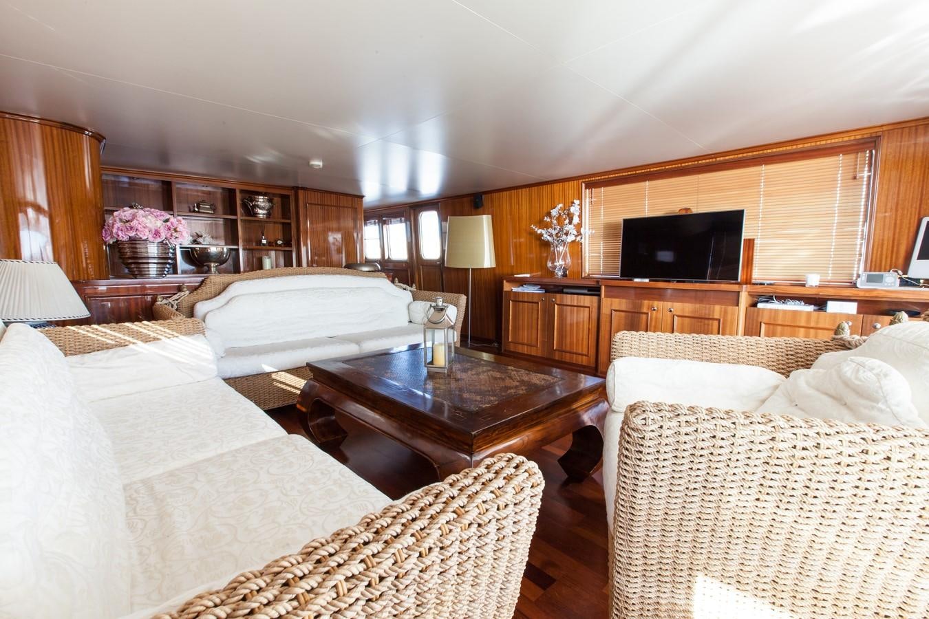 a bedroom with a tv and a table aboard ANTARES OF BRITAIN Yacht for Sale