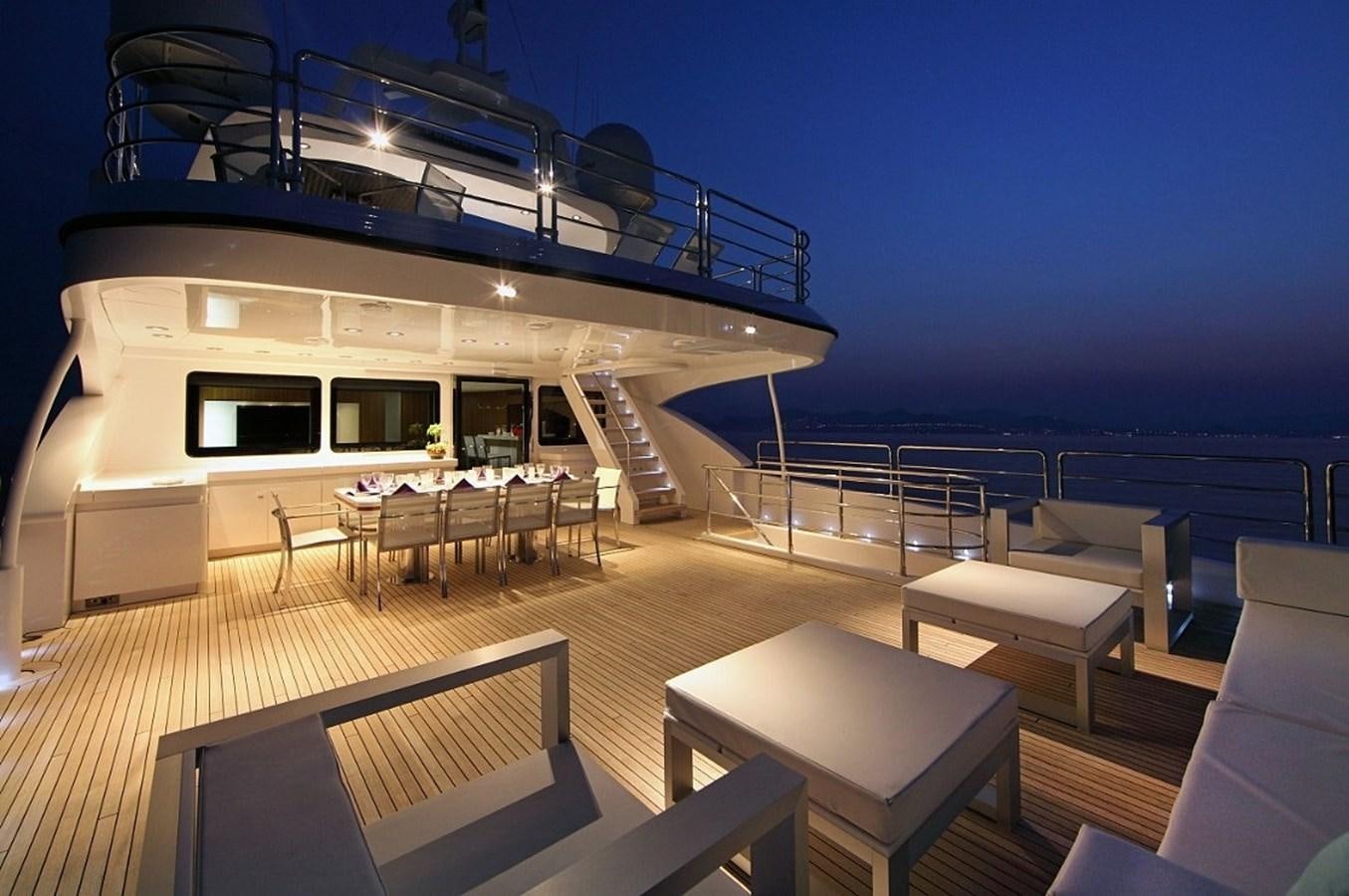 a balcony with a table and chairs aboard SEA SHELL Yacht for Sale