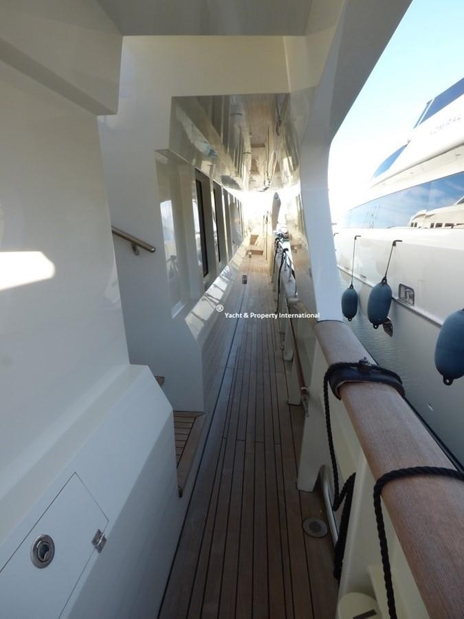 a wooden walkway with white walls aboard BENETTI STYLE Yacht for Sale