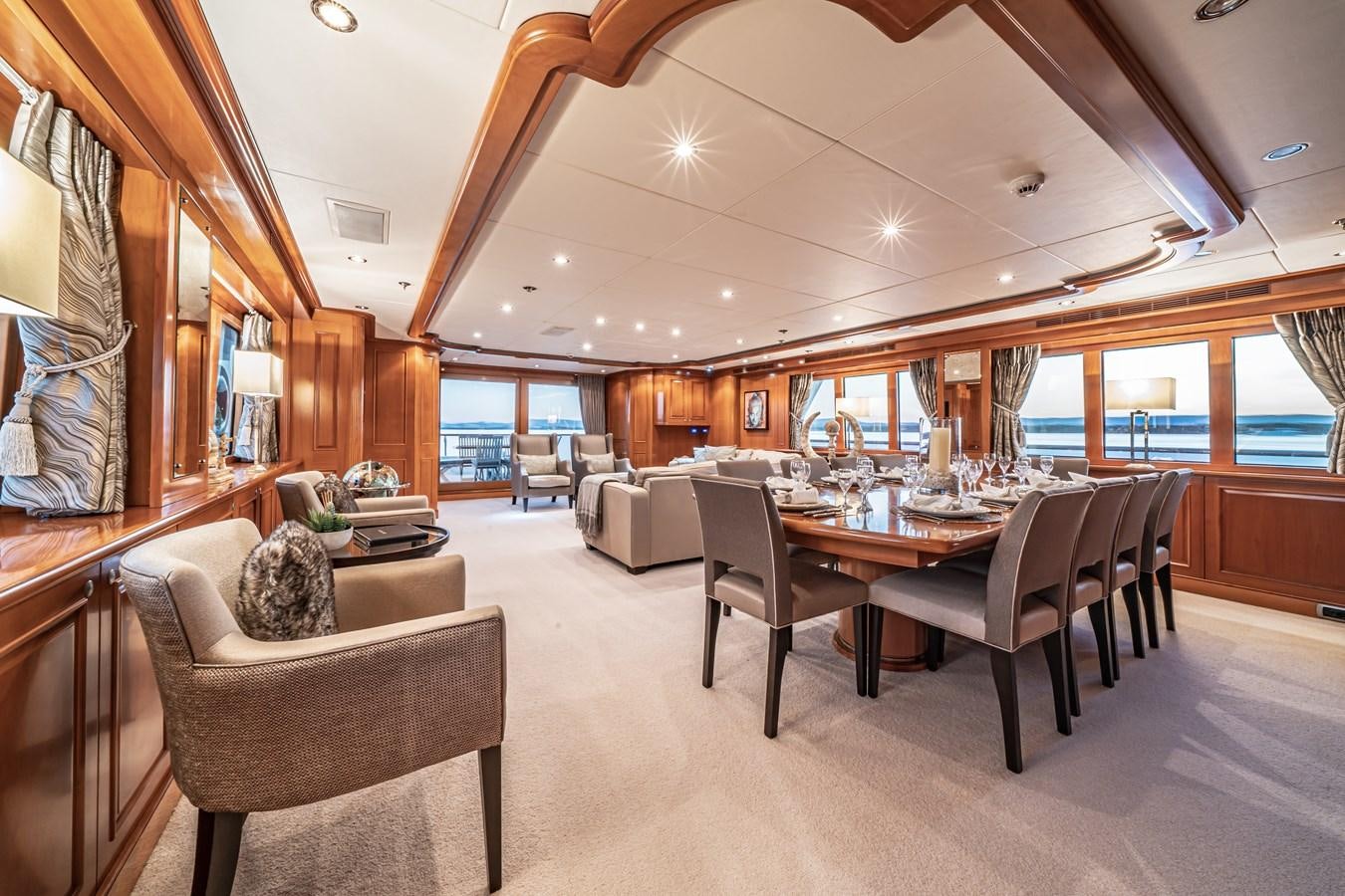 a large living room with a large table and chairs aboard RELENTLESS Yacht for Sale