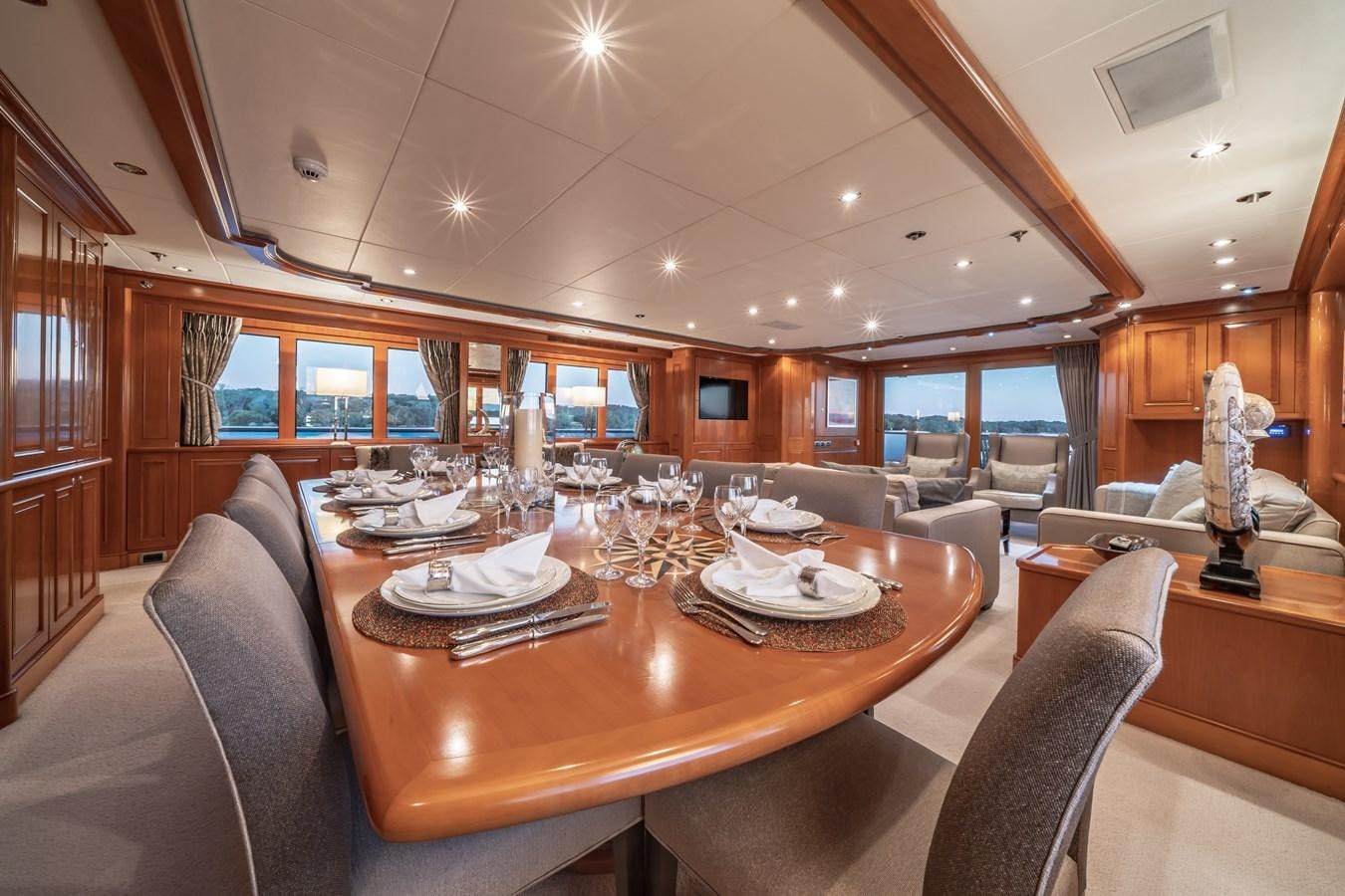 a dining room with a large wood table and chairs aboard RELENTLESS Yacht for Sale