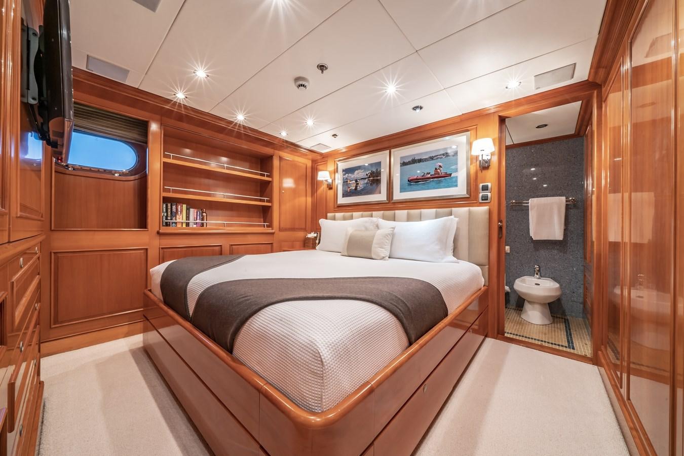 a bedroom with a bed and a closet aboard RELENTLESS Yacht for Sale