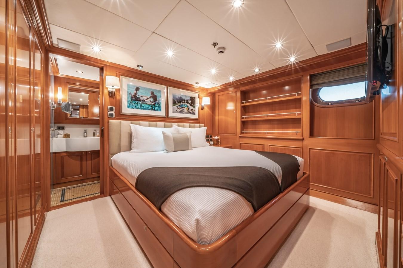 a room with a bed and a mirror aboard RELENTLESS Yacht for Sale