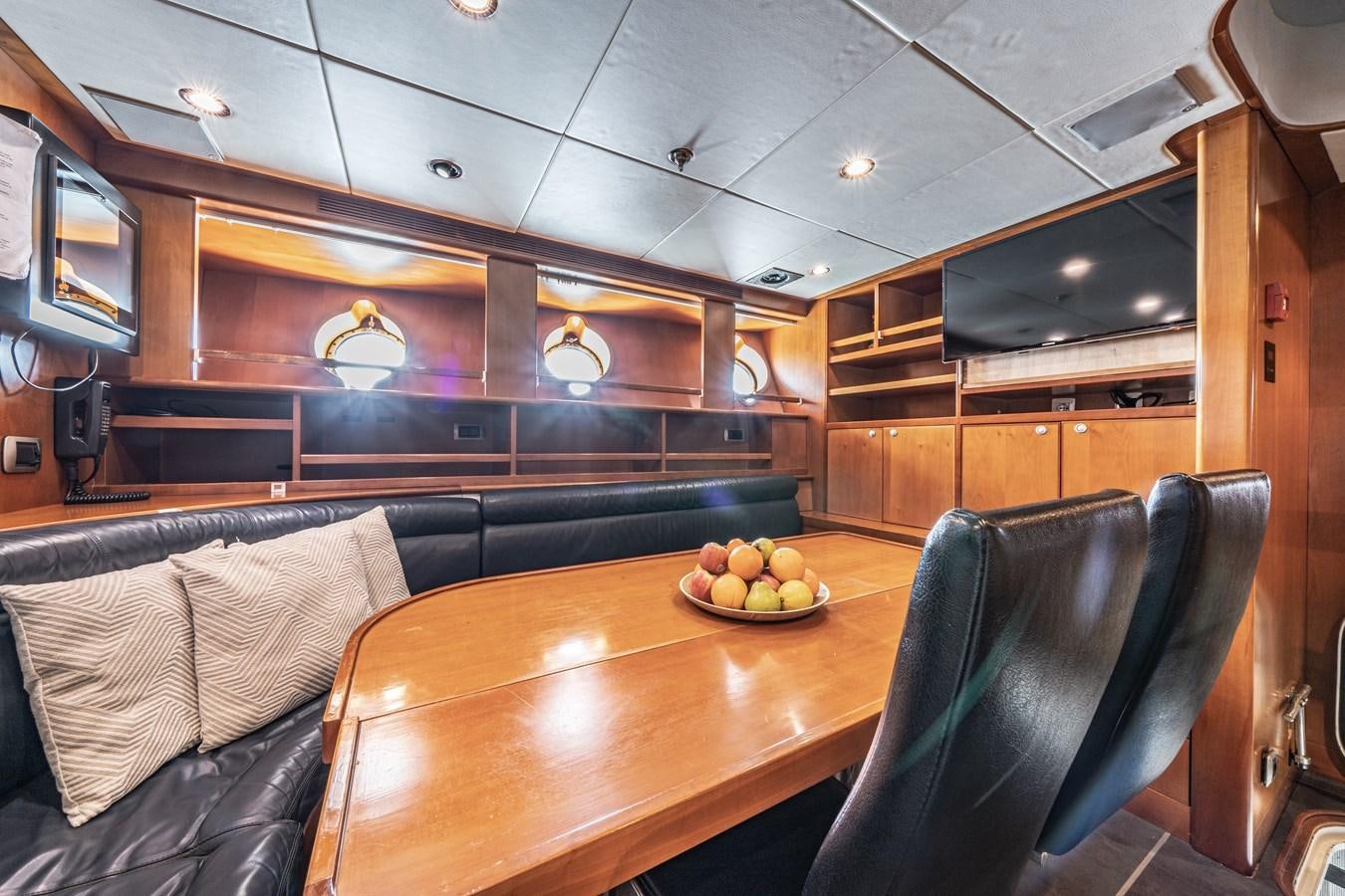 a kitchen with wooden cabinets aboard RELENTLESS Yacht for Sale