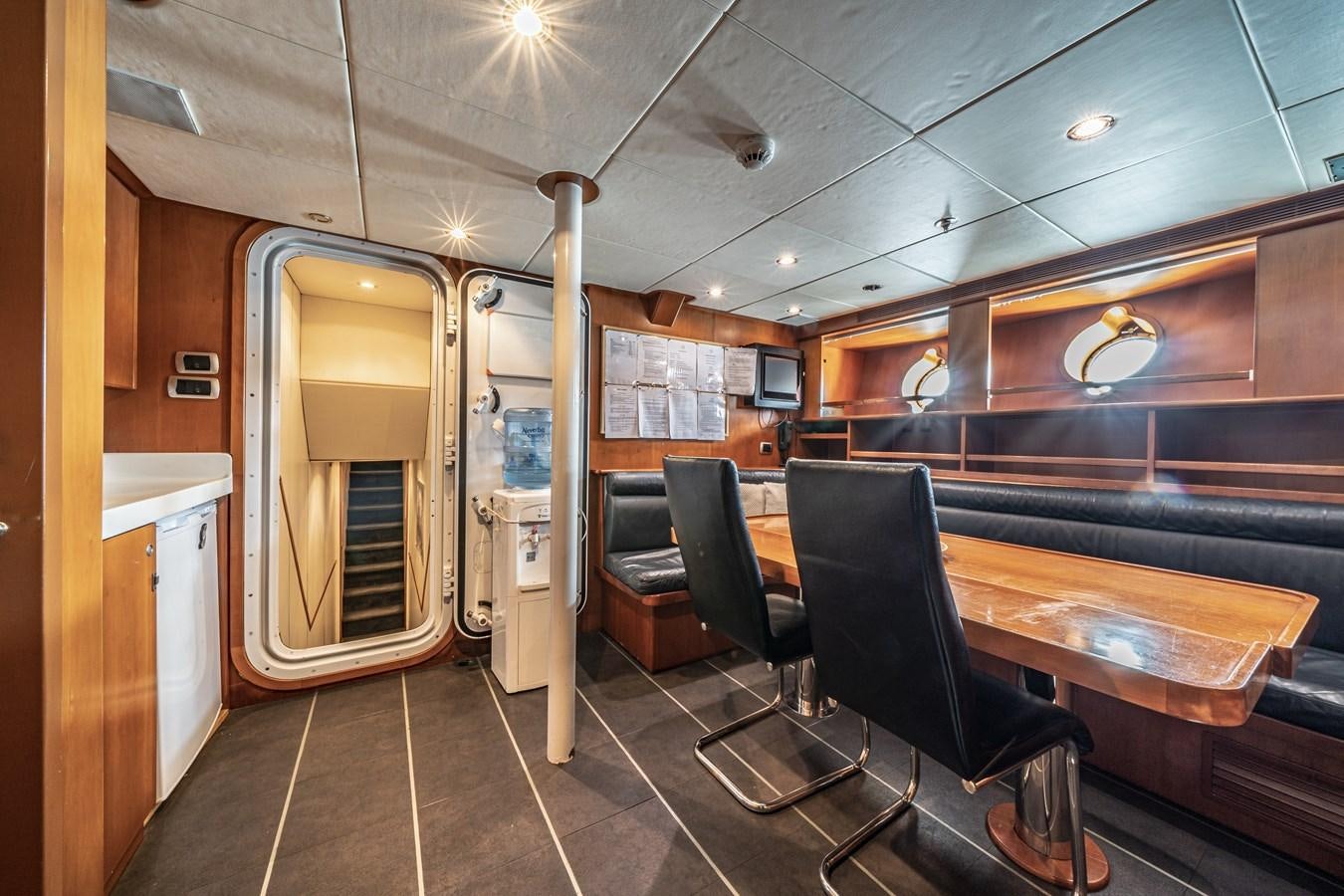 a room with a table and chairs aboard RELENTLESS Yacht for Sale