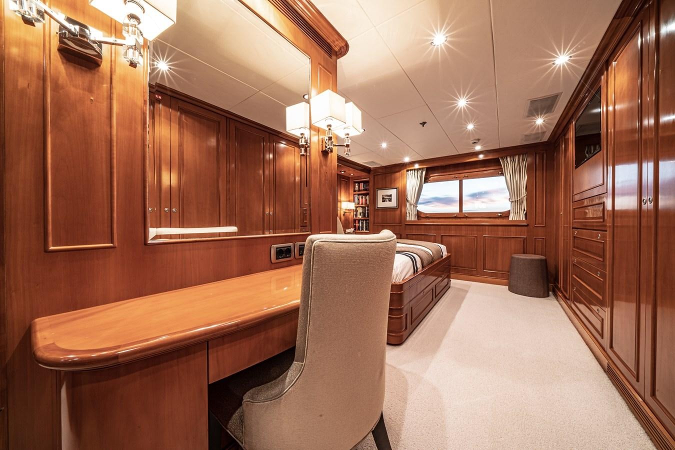 a room with a bed and a chair aboard RELENTLESS Yacht for Sale