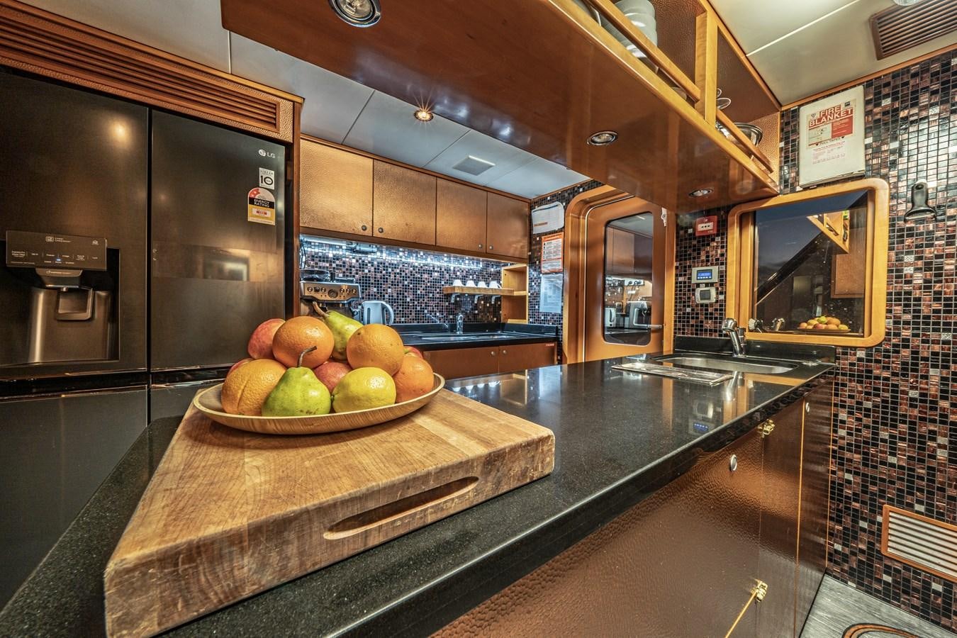 a bowl of fruit on a counter aboard RELENTLESS Yacht for Sale