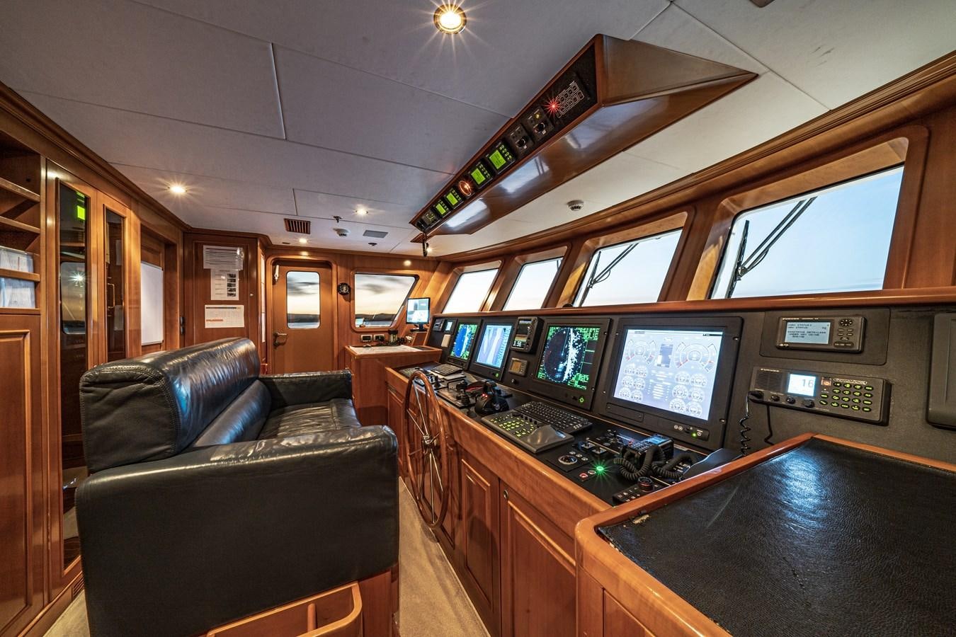 a room with a couch and a television aboard RELENTLESS Yacht for Sale
