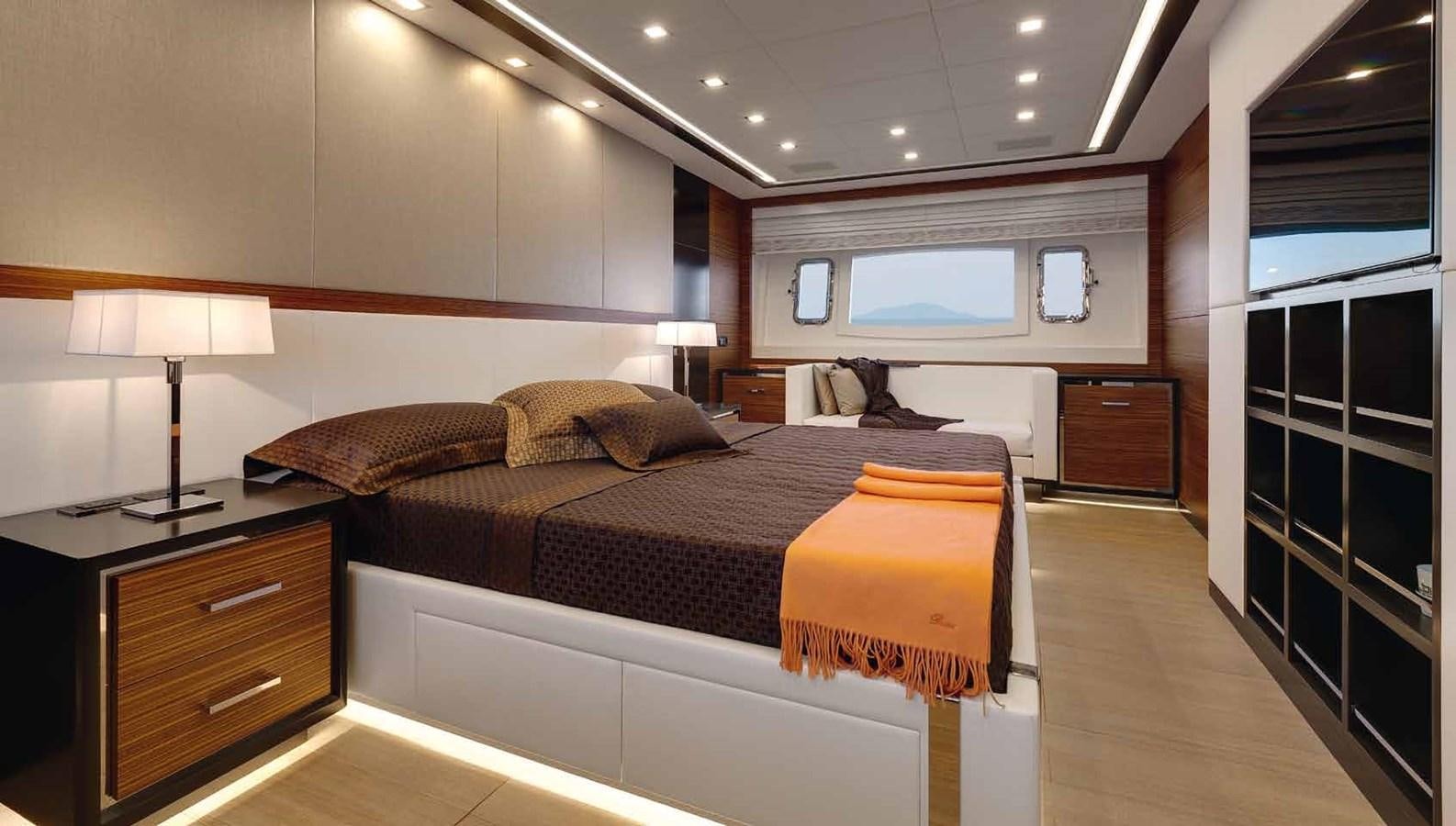 a bedroom with a bed and a desk aboard AXTANA Yacht for Sale