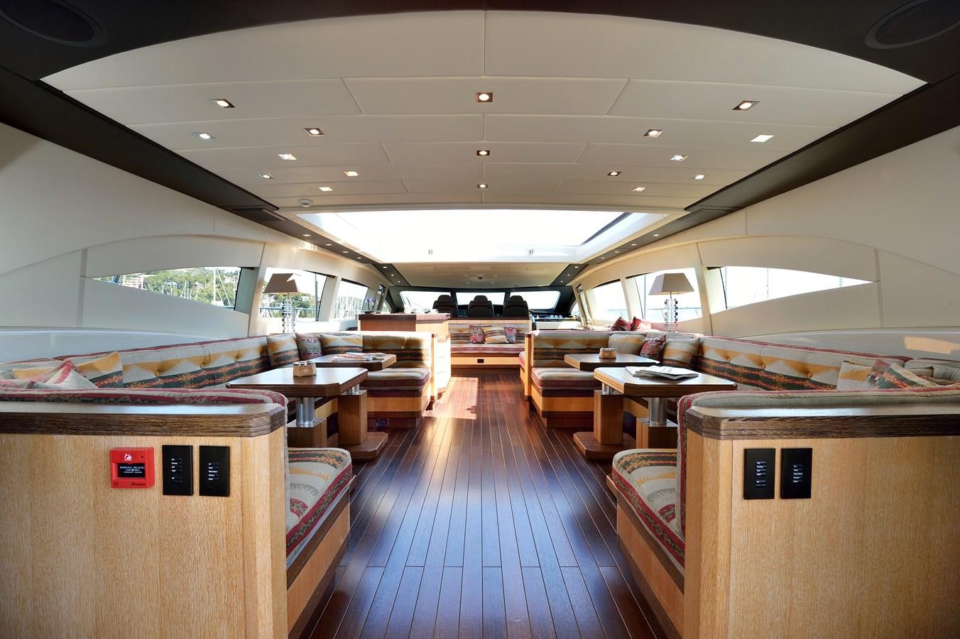 a room with tables and chairs aboard MANGUSTA 108 - BECOOL - CAREFULLY USED Yacht for Sale