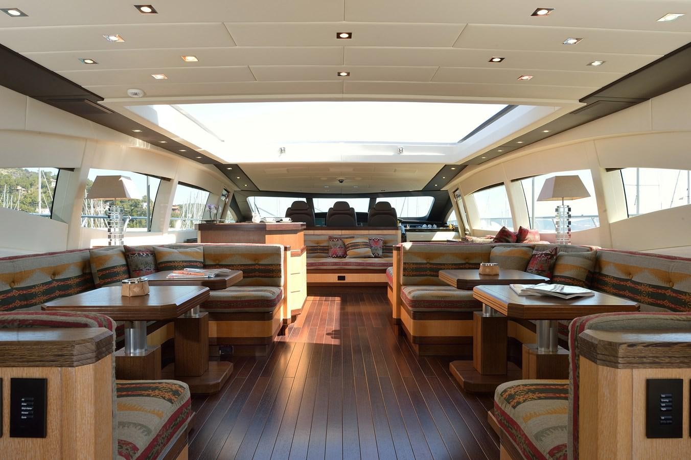 a room with wooden tables and chairs aboard MANGUSTA 108 - BECOOL - CAREFULLY USED Yacht for Sale