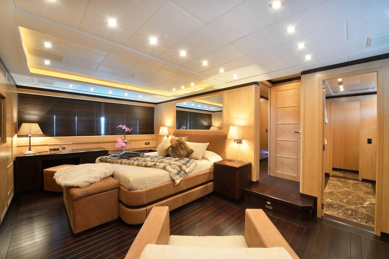 a living room with a couch and a wood cabinet aboard MANGUSTA 108 - BECOOL - CAREFULLY USED Yacht for Sale