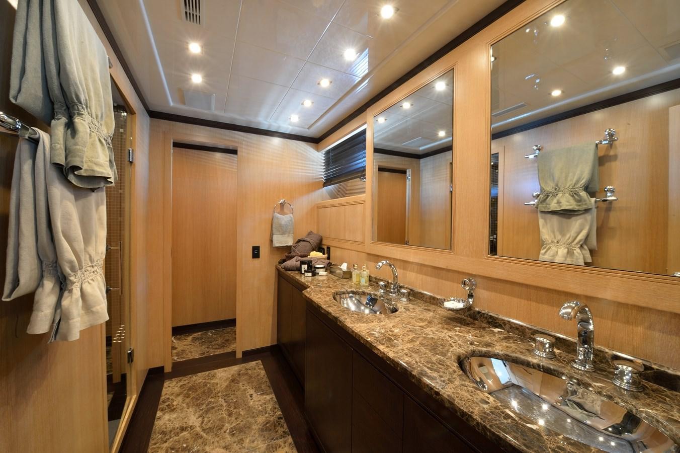 a bathroom with a countertop sink and mirrors aboard MANGUSTA 108 - BECOOL - CAREFULLY USED Yacht for Sale