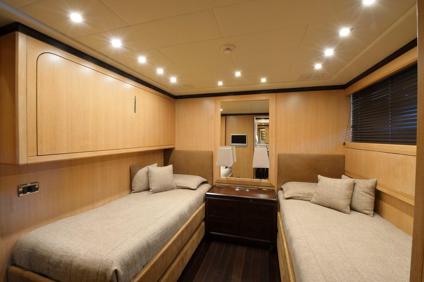 a hotel room with a bed and a mirror aboard MANGUSTA 108 - BECOOL - CAREFULLY USED Yacht for Sale