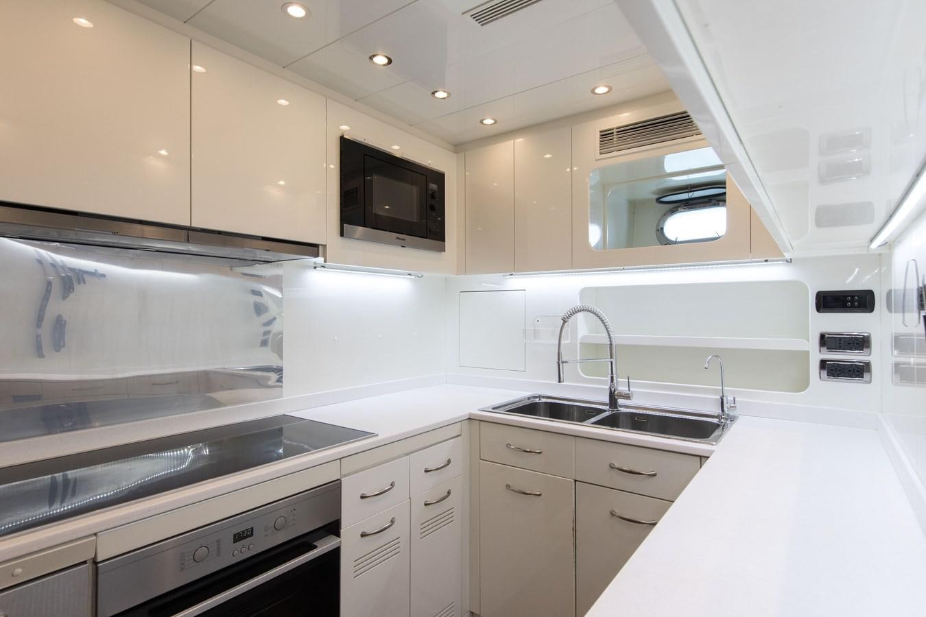 a kitchen with white cabinets aboard FATAMORGANA Yacht for Sale