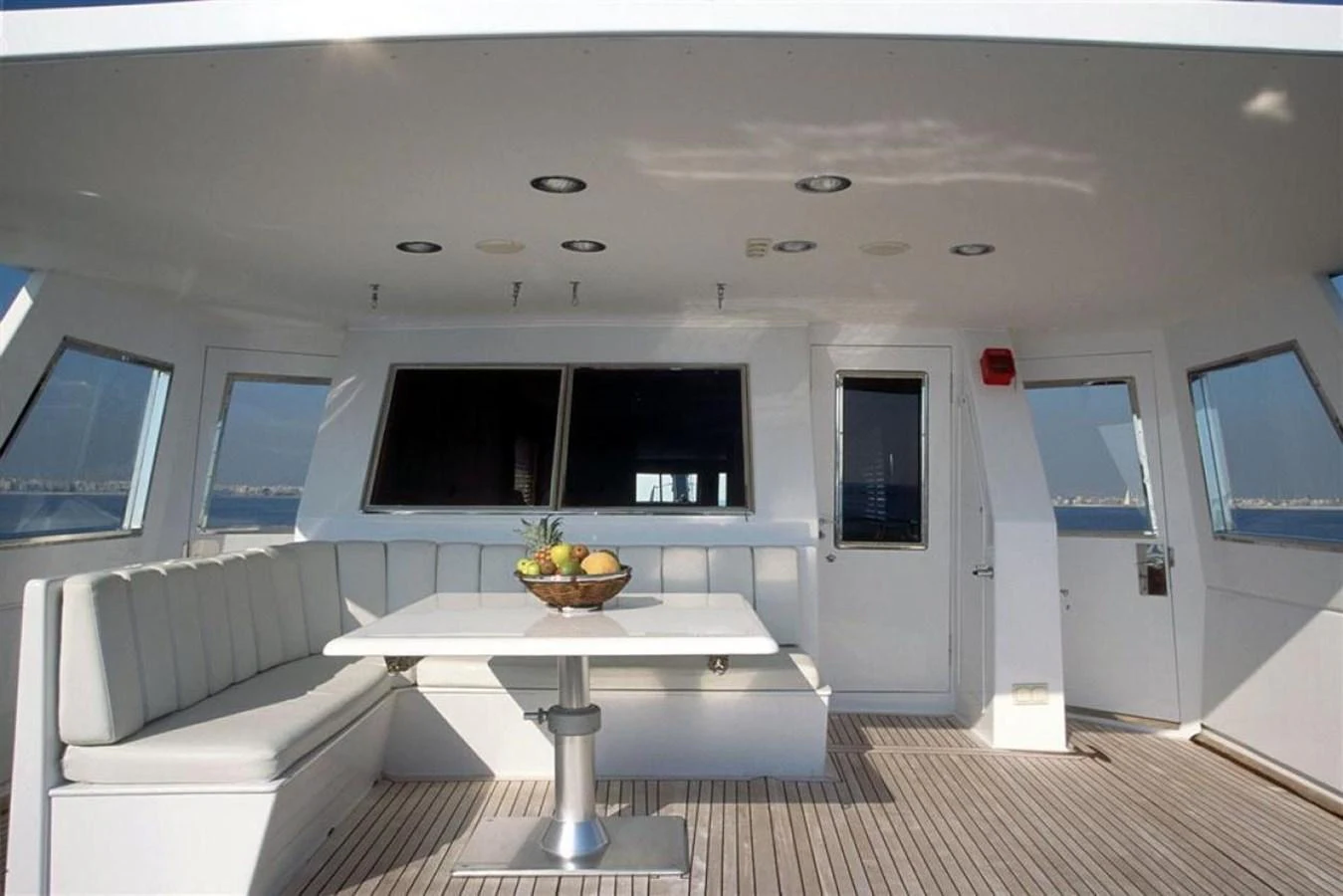 a room with a table and couch aboard ALLAHOU Yacht for Sale