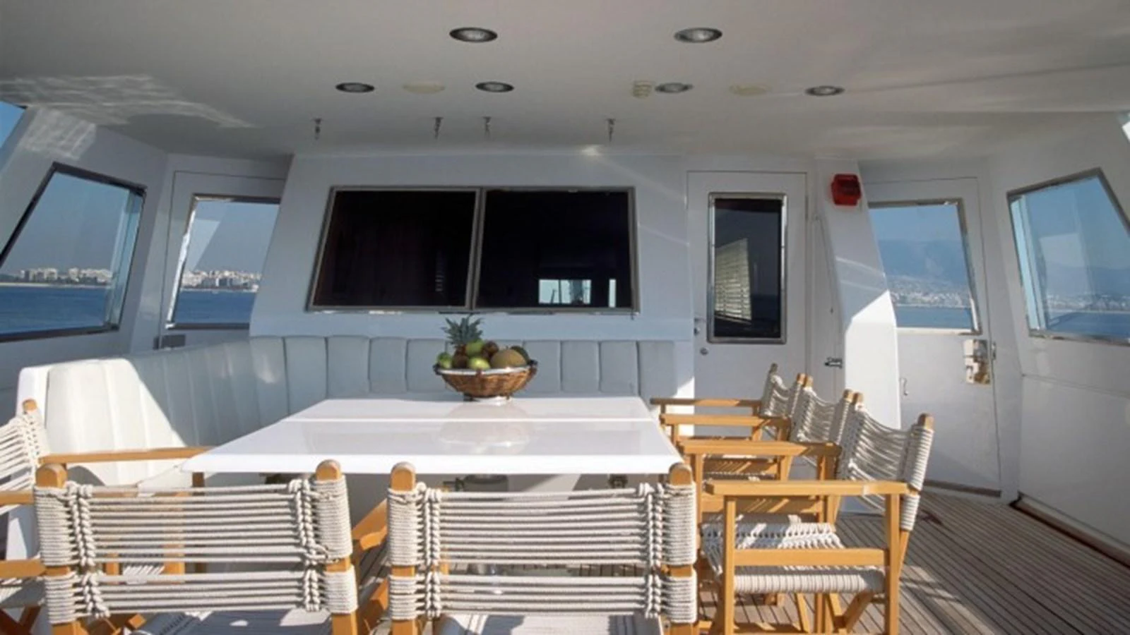 a room with tables and chairs aboard ALLAHOU Yacht for Sale