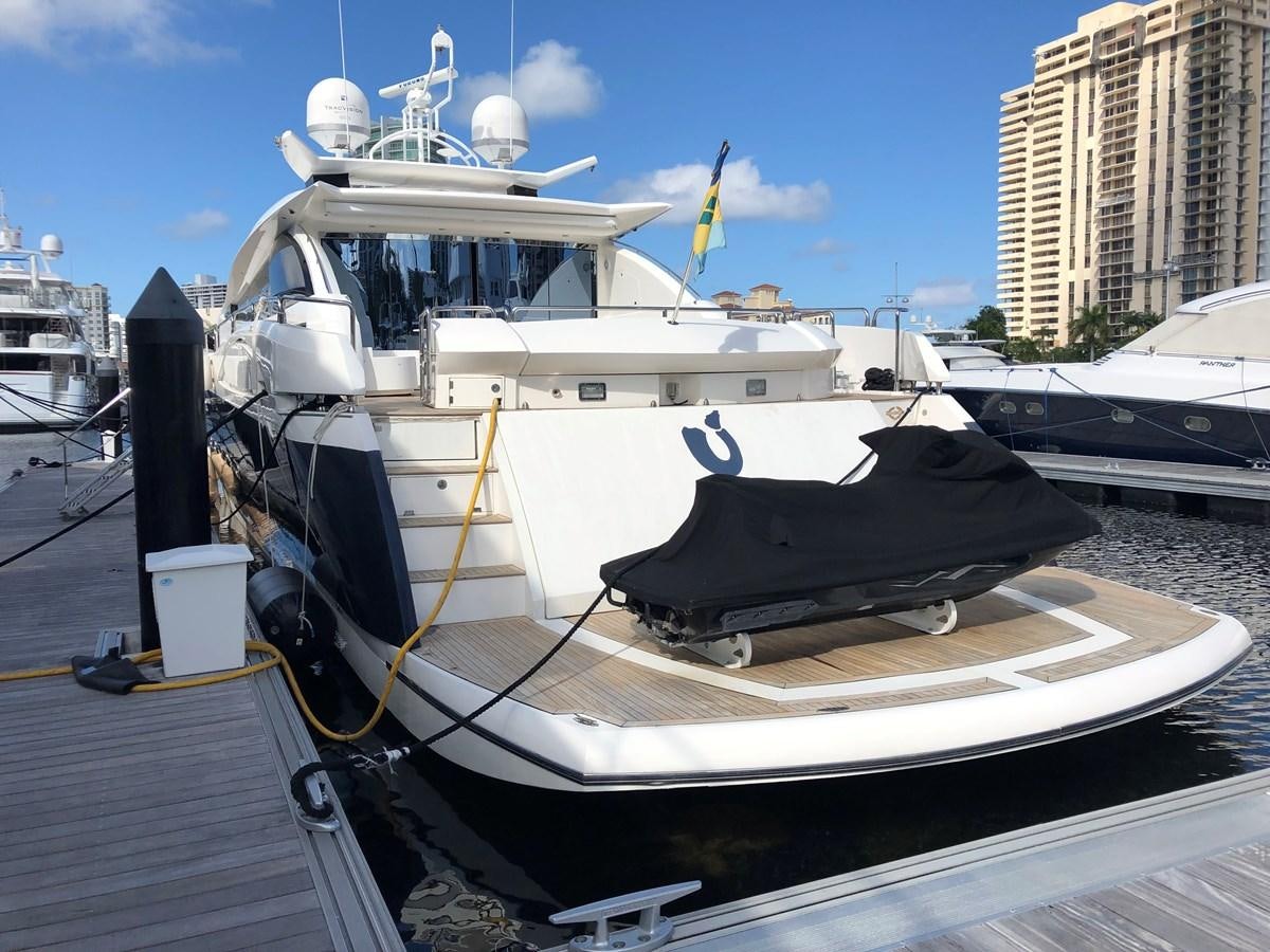 a boat docked at a pier aboard UNICO Yacht for Sale