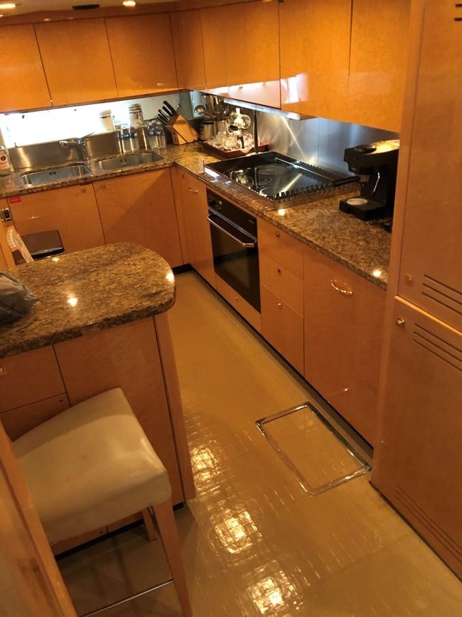 a kitchen with a countertop sink and a stool aboard UNICO Yacht for Sale