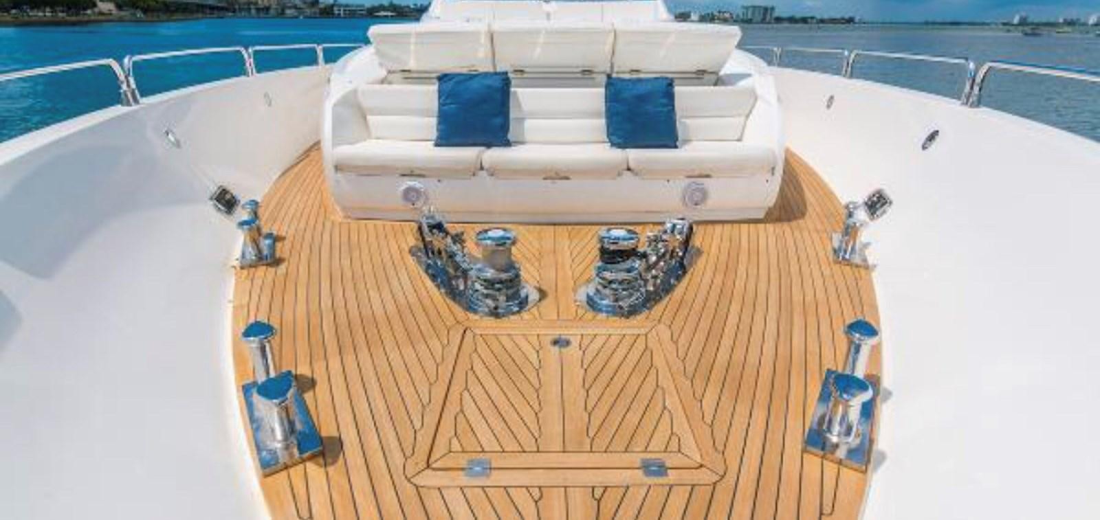 a white boat on a wooden deck aboard UNICO Yacht for Sale