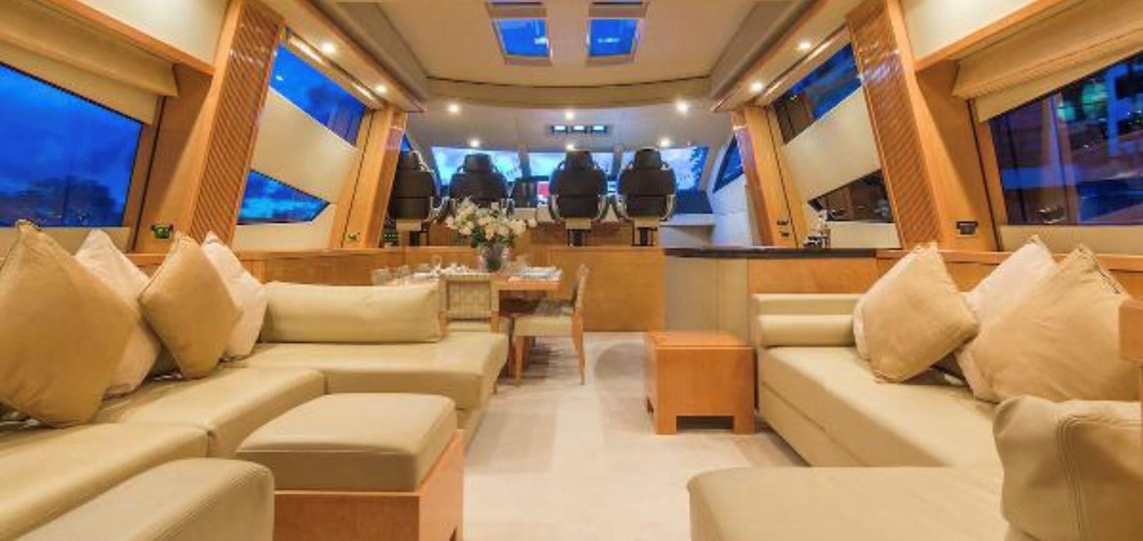 a room with couches and a table aboard UNICO Yacht for Sale