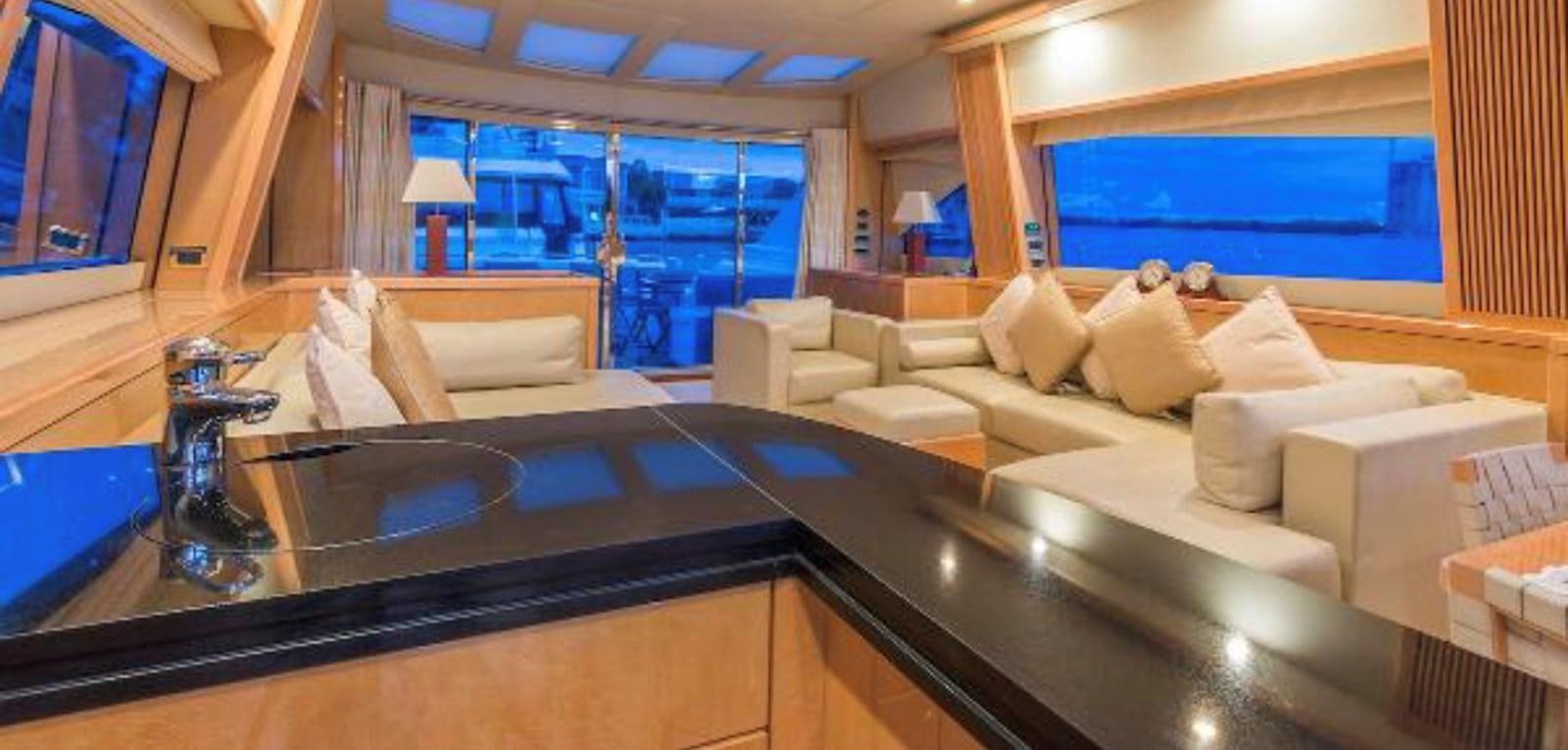 a room with a large bar and a large sofa aboard UNICO Yacht for Sale