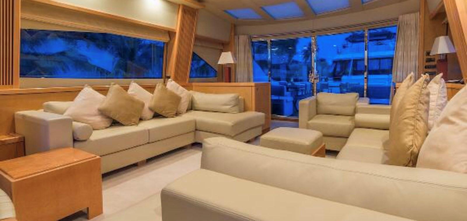 a room with a couch and a table aboard UNICO Yacht for Sale