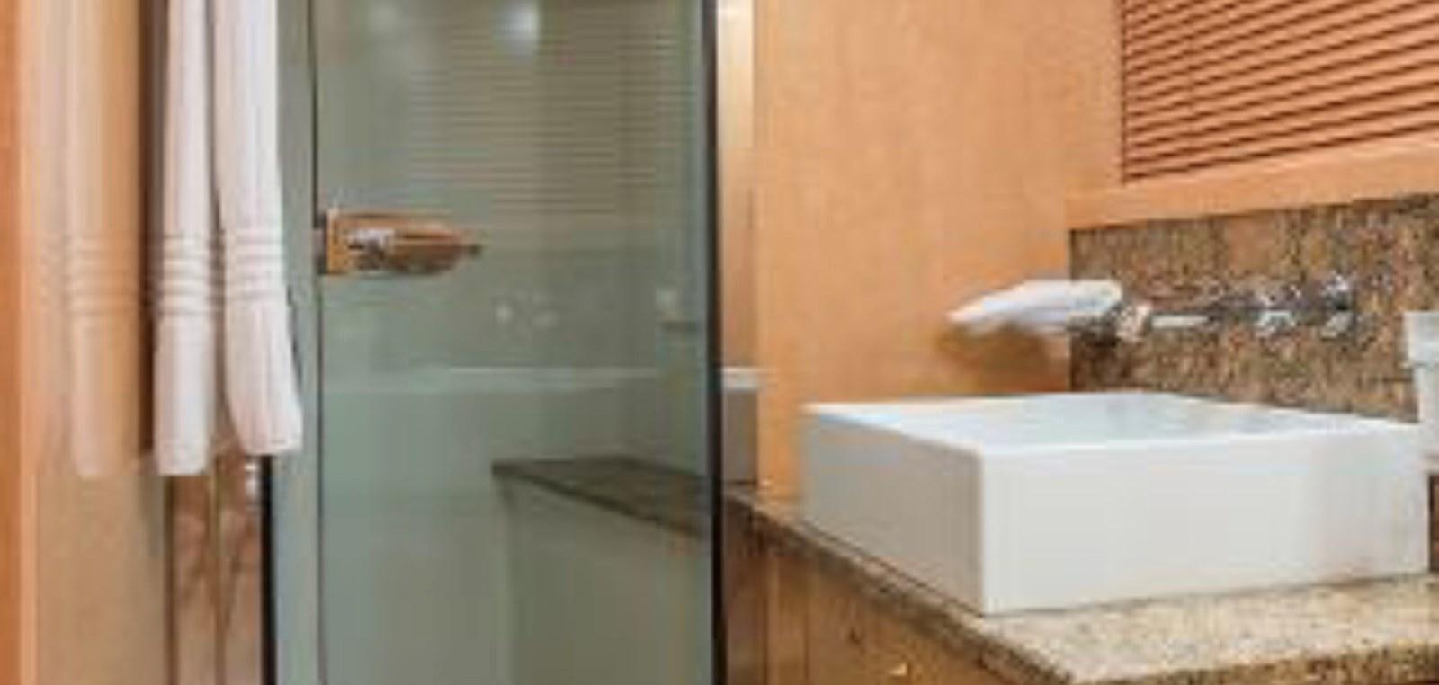 a bathroom with a bathtub and a sink aboard UNICO Yacht for Sale