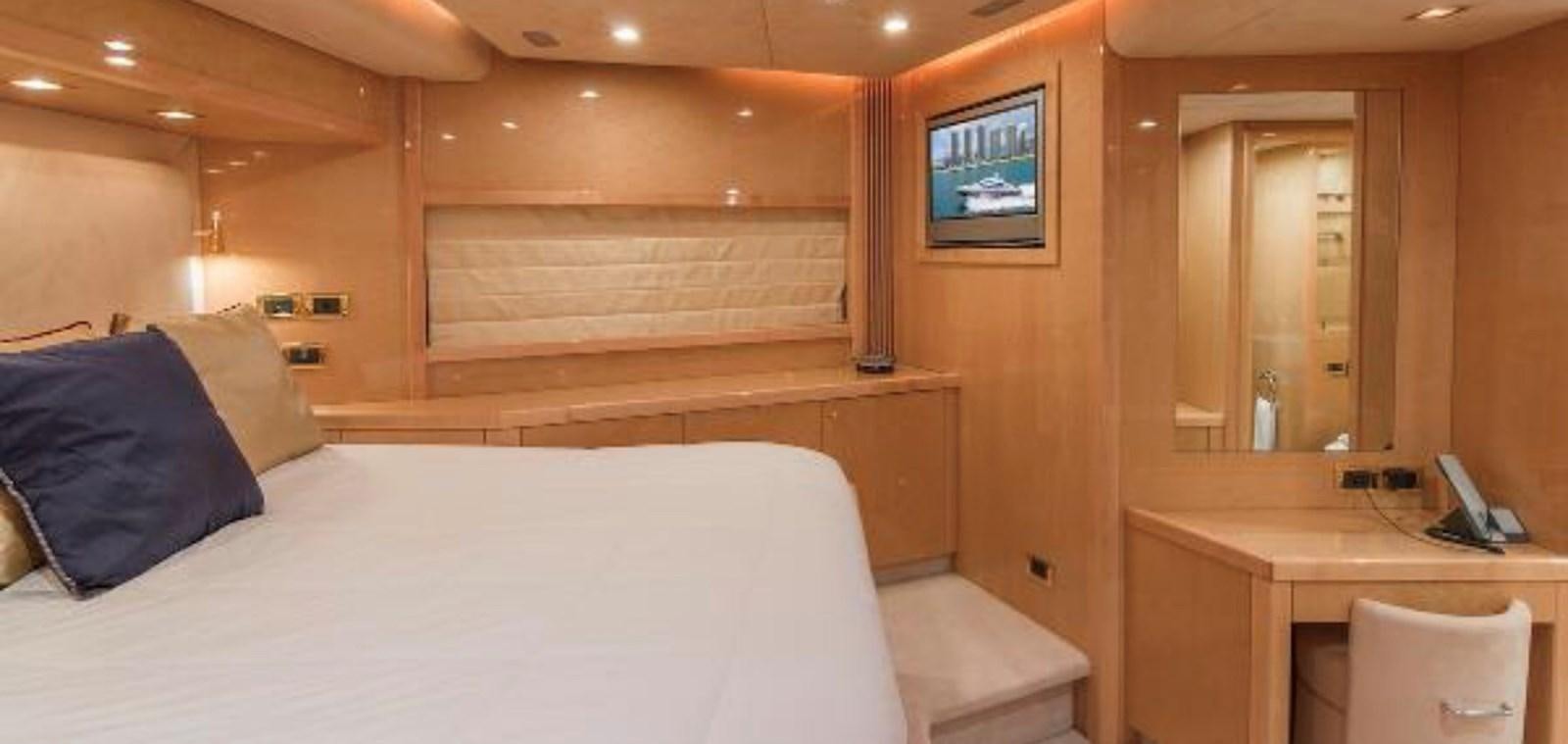a room with a bed and a desk aboard UNICO Yacht for Sale
